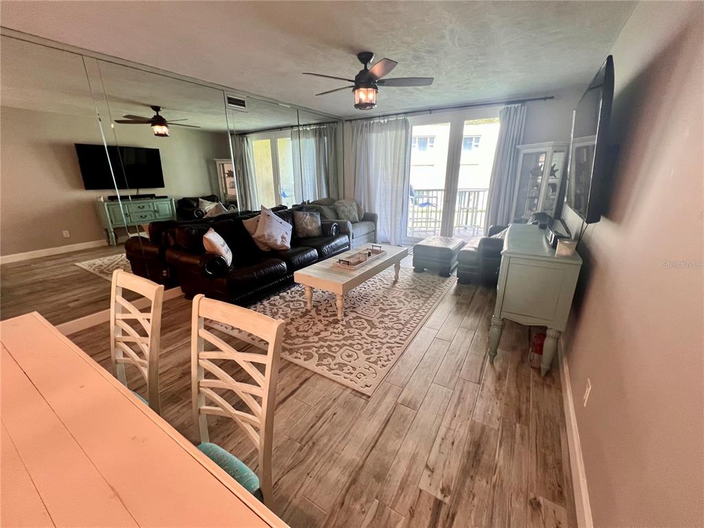 4565 South Atlantic Avenue, Unit 5203 Ponce Inlet, FL 32127 - Photo 13 of 28 a living room with furniture and a flat screen tv