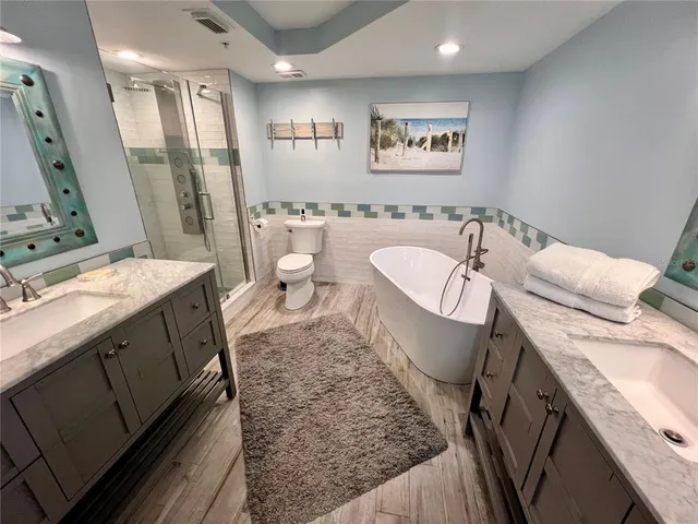 a spacious bathroom with a granite countertop sink and a mirror