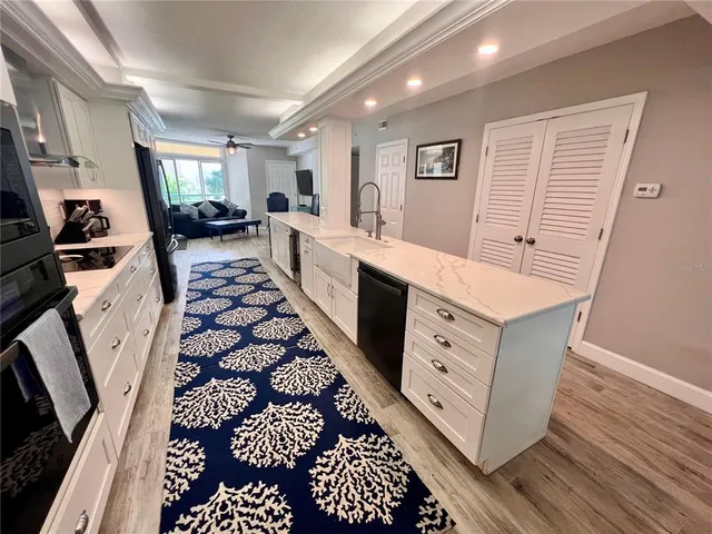 a large white kitchen with stainless steel appliances