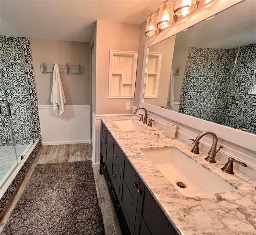 4565 South Atlantic Avenue, Unit 5203 Ponce Inlet, FL 32127 - Photo 25 of 28 a bathroom with a granite countertop sink a mirror and shower
