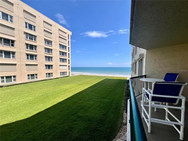 a view of an chairs and table tv in the back yard