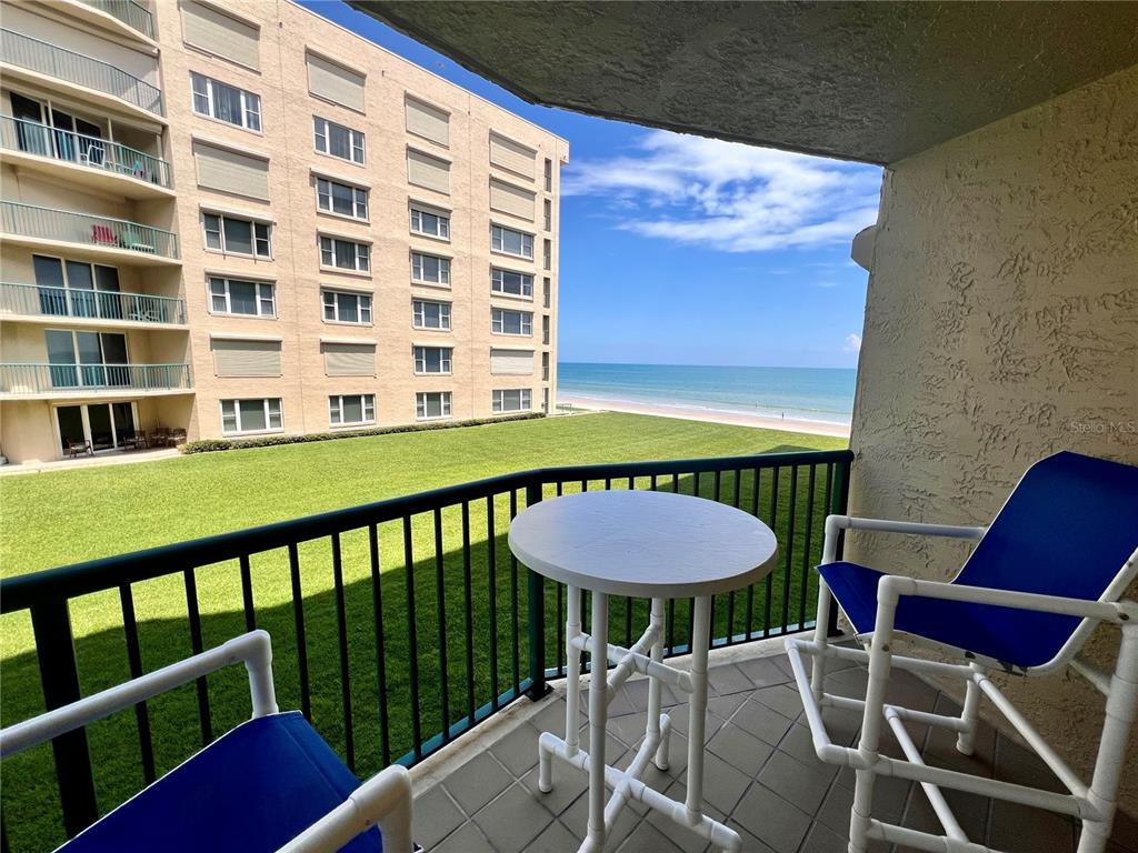 4565 South Atlantic Avenue, Unit 5203 Ponce Inlet, FL 32127 - Photo 6 of 28 a view of a chairs and table in the balcony