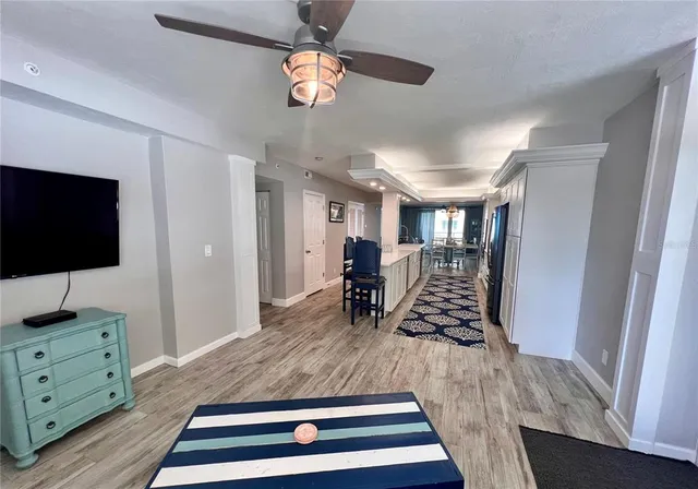 a view of a room with furniture and wooden floor