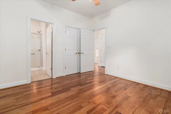 a view of an empty room with wooden floor