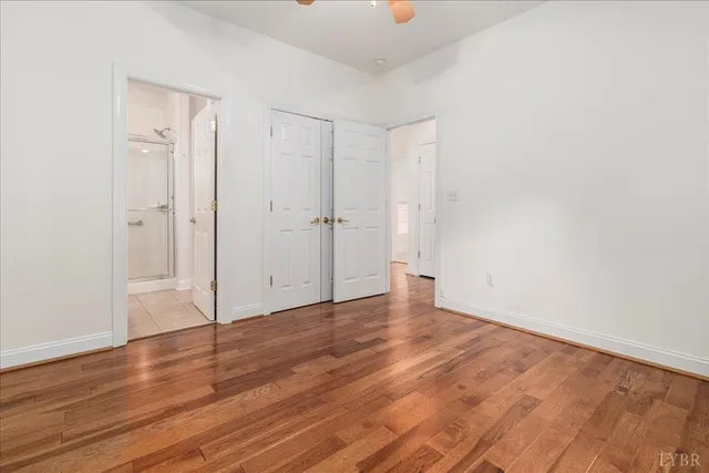 a view of an empty room with wooden floor