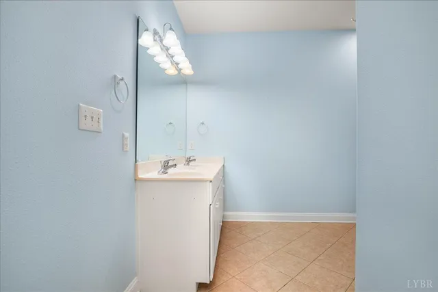 a bathroom with a sink vanity and a mirror