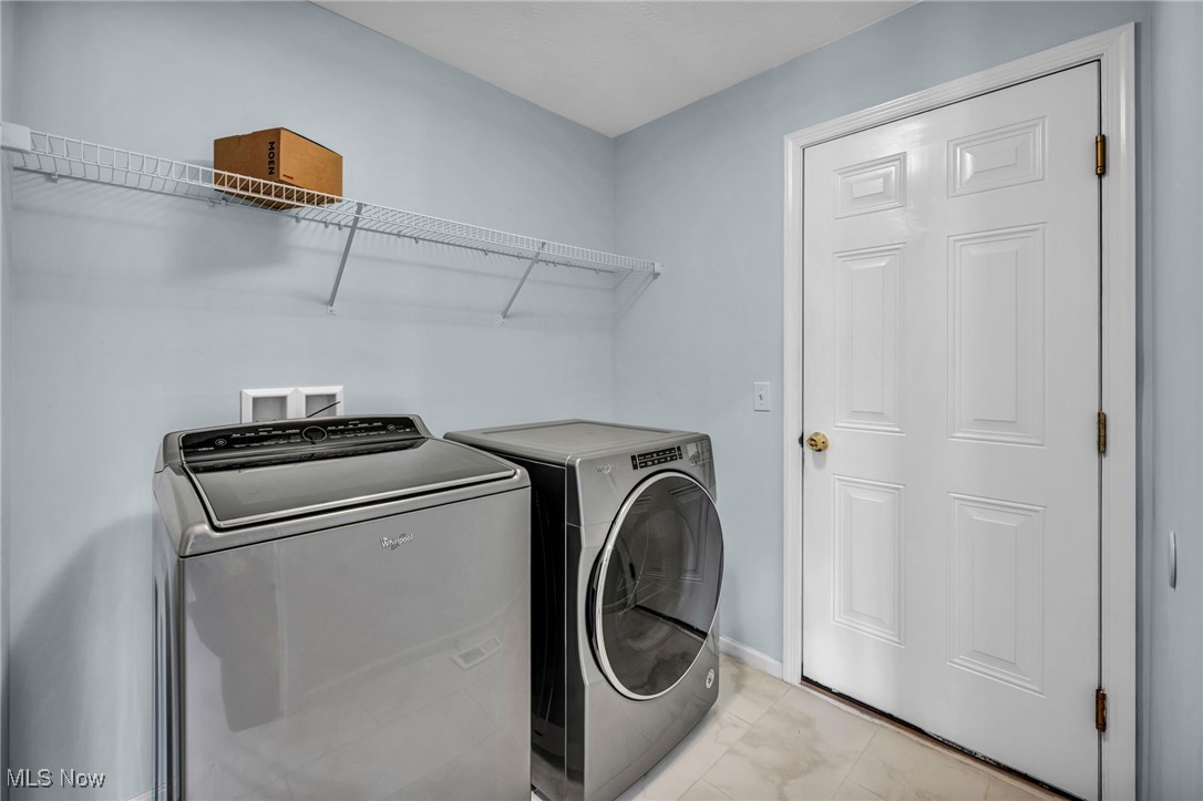 143 Stone Ridge Way Berea, OH 44017 - Photo 5 of 47 Laundry area with washer and dryer and light marble finish flooring