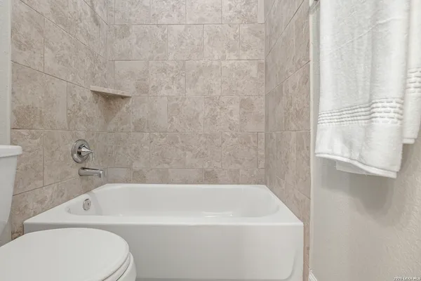 a bathroom with a bathtub and toilet