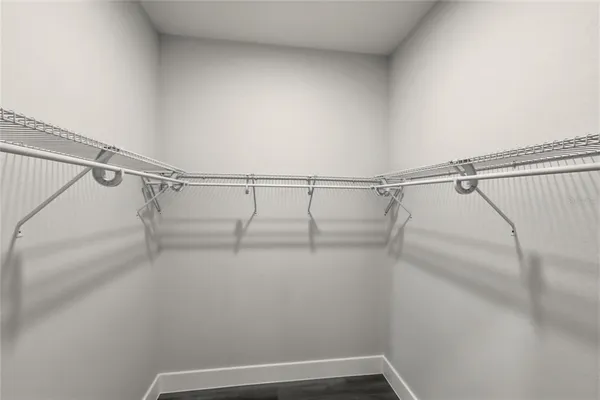 a view of walk in closet with empty racks