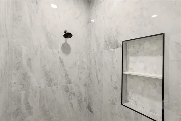 a bathroom with a glass shower door