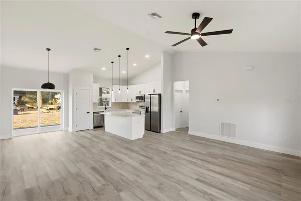 a view of a kitchen with wooden floor and a sink