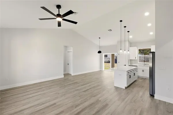 an open kitchen with white cabinets and stainless steel appliances