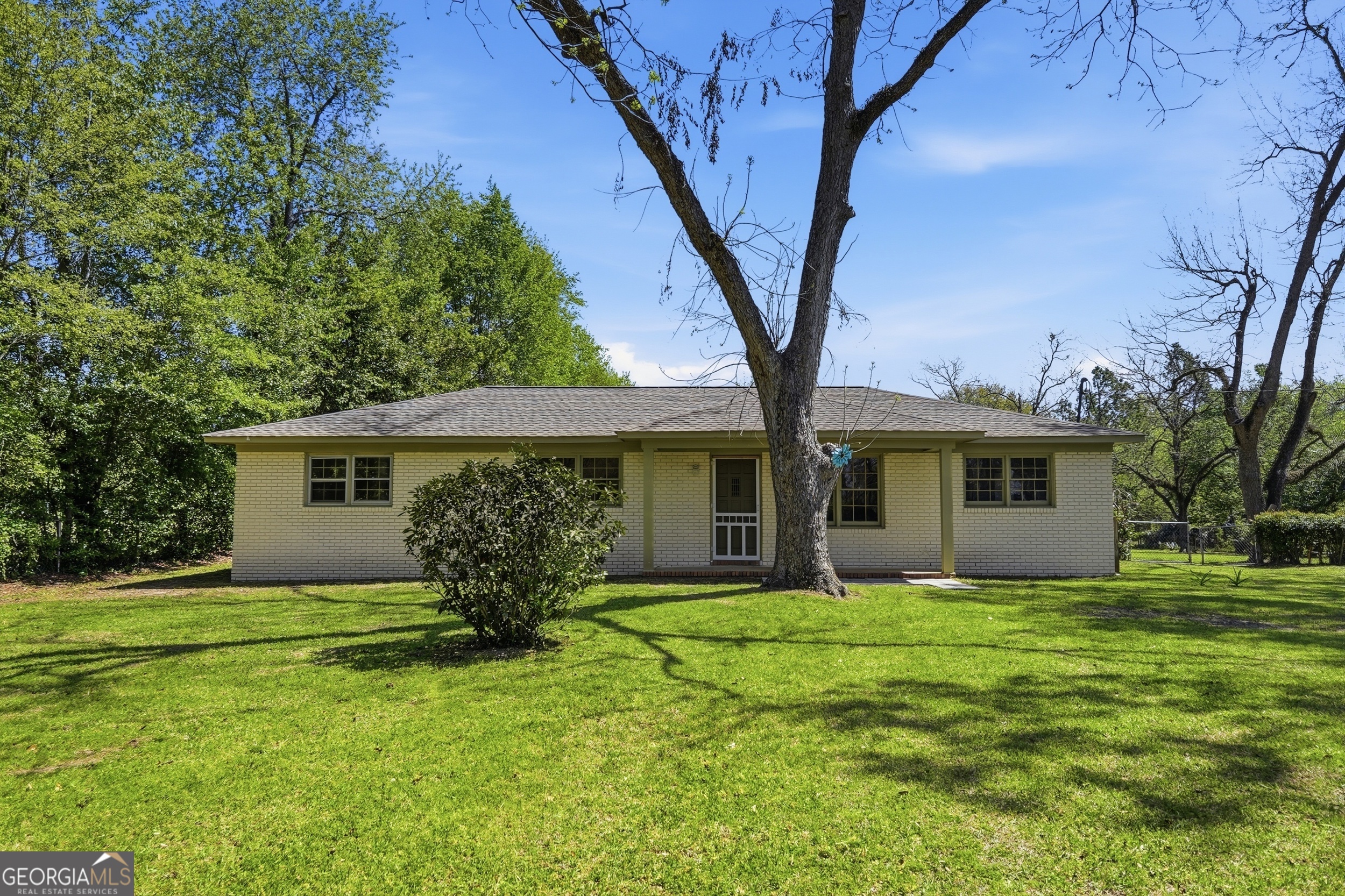 a front view of house with yard and trees