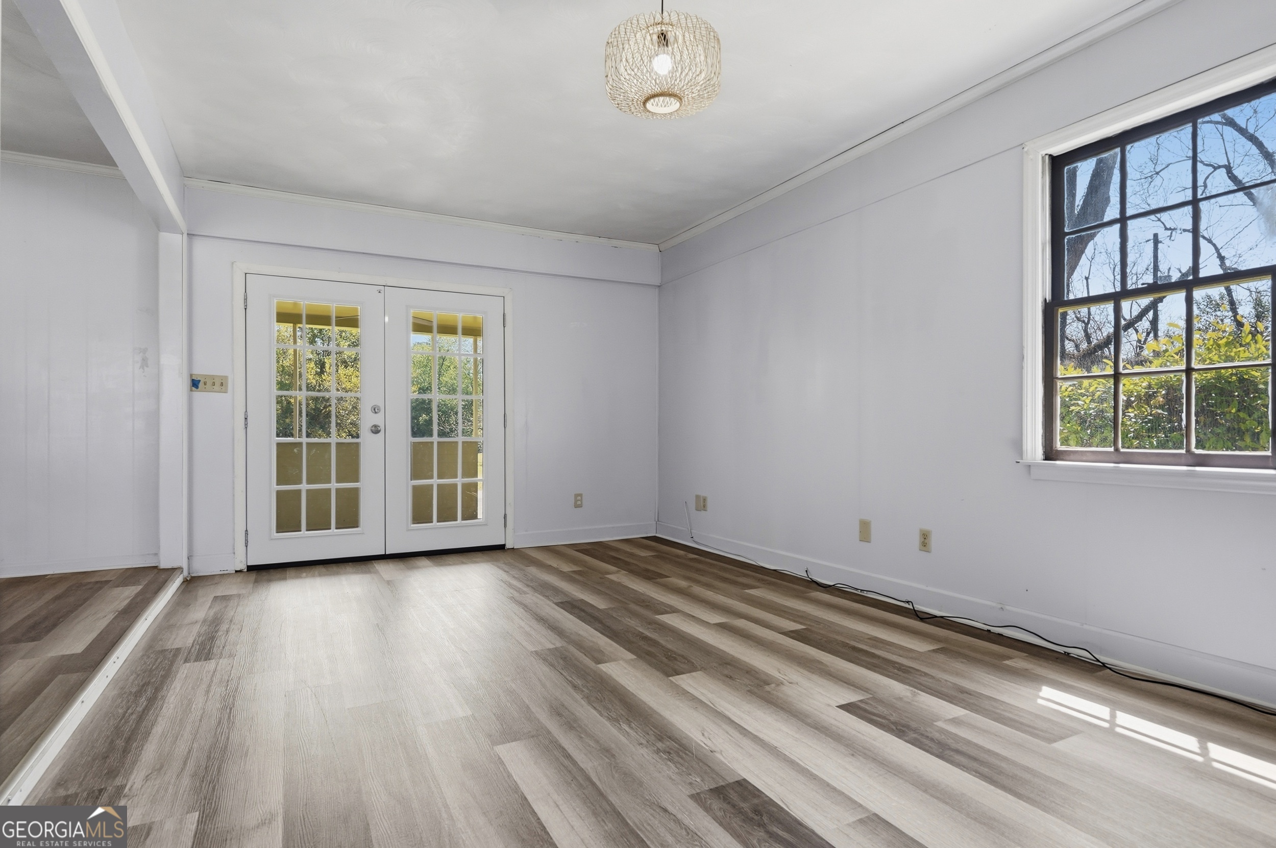 3710 Coakley Avenue Albany, GA 31721 - Photo 17 of 47 a view of an empty room with a window and wooden floor