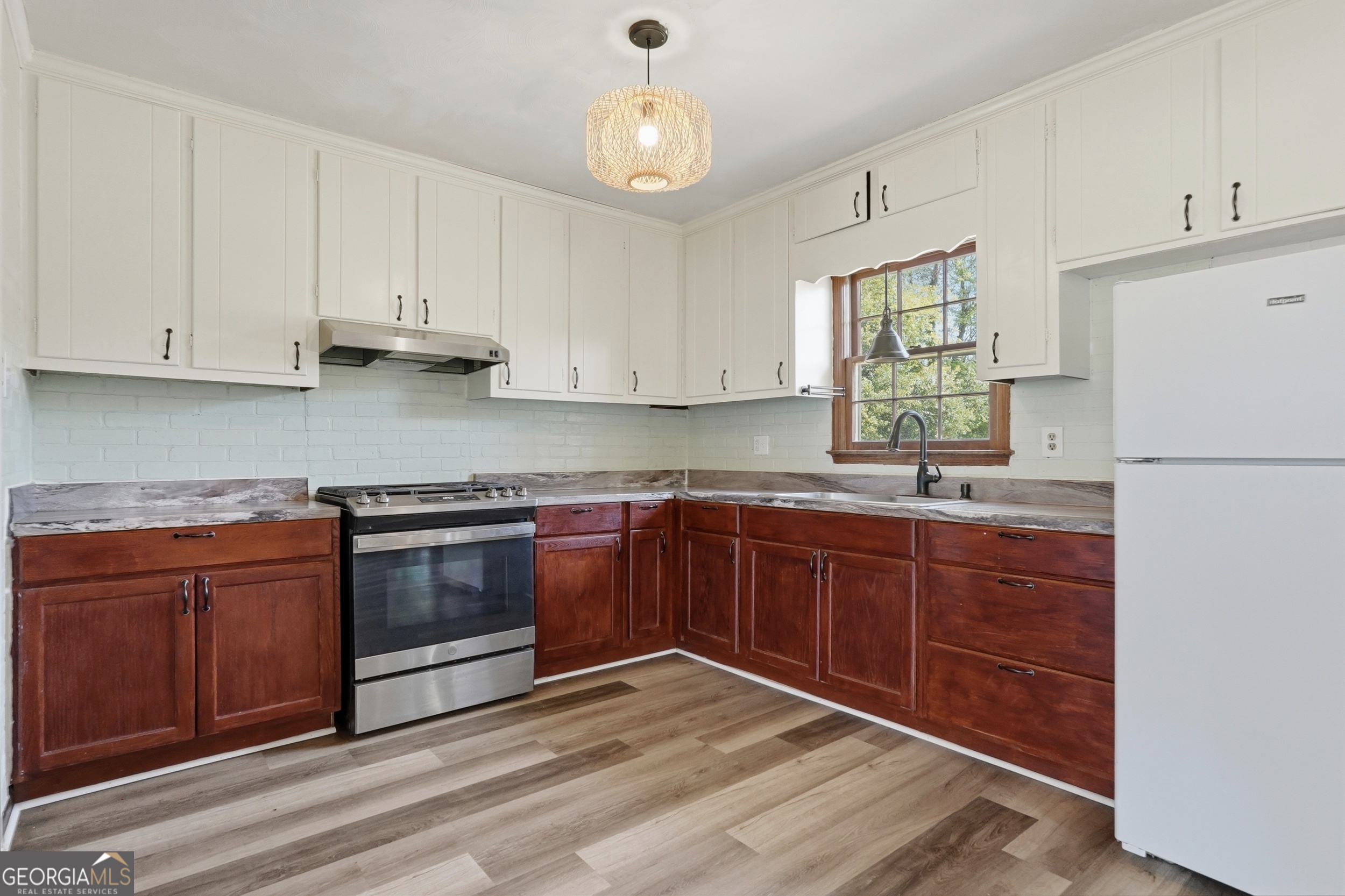 3710 Coakley Avenue Albany, GA 31721 - Photo 21 of 47 a kitchen with granite countertop a refrigerator sink and cabinets