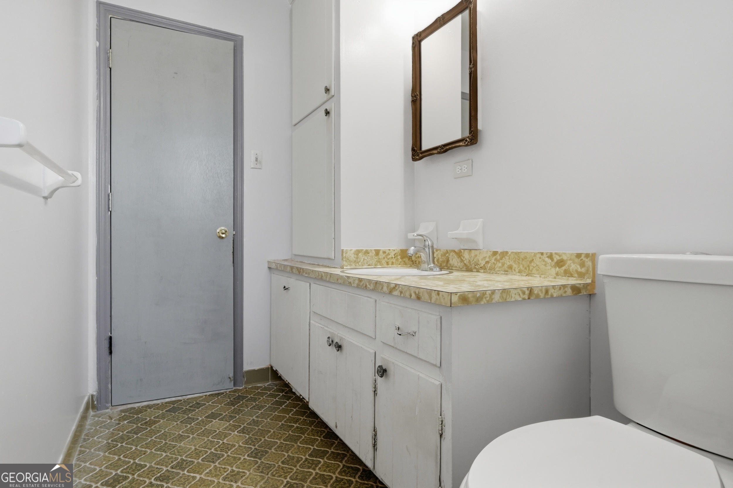 3710 Coakley Avenue Albany, GA 31721 - Photo 32 of 47 a bathroom with a granite countertop sink a toilet and mirror