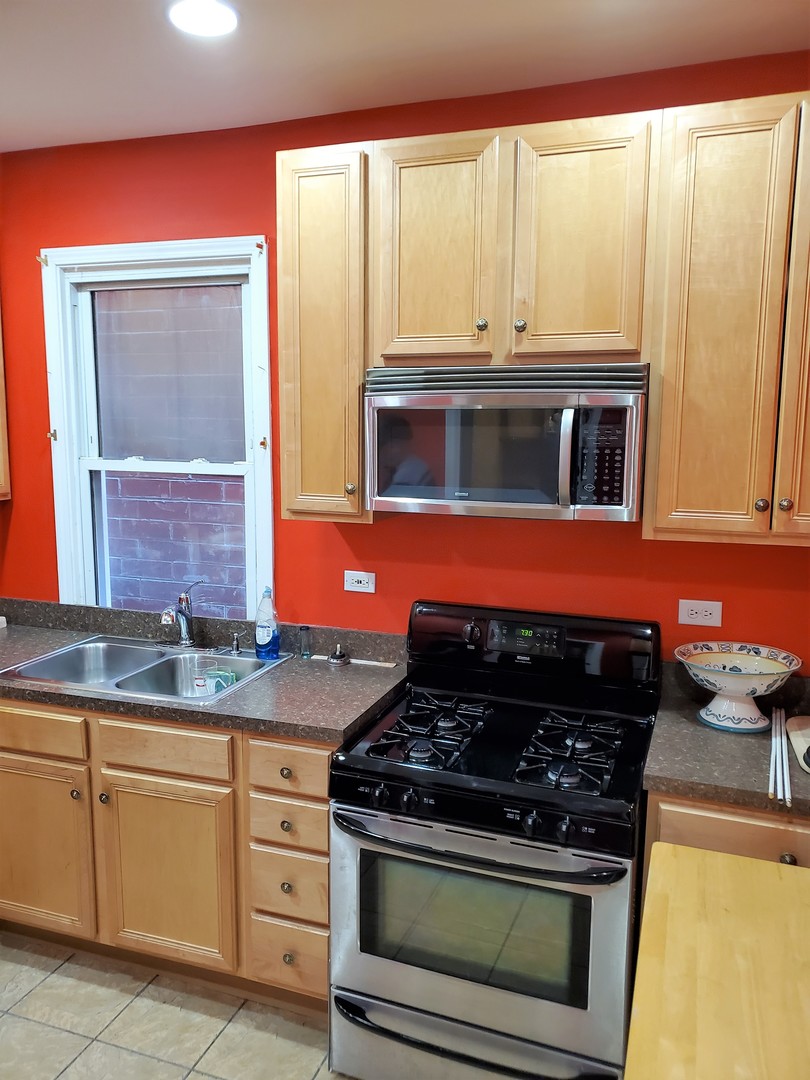 3539 North Pulaski Road Chicago, IL 60641 - Photo 16 of 23 a kitchen with stainless steel appliances granite countertop a stove and a microwave