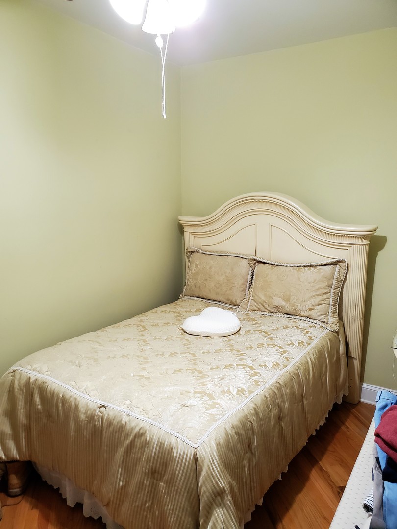 3539 North Pulaski Road Chicago, IL 60641 - Photo 19 of 23 a bedroom with a bed and a night stand