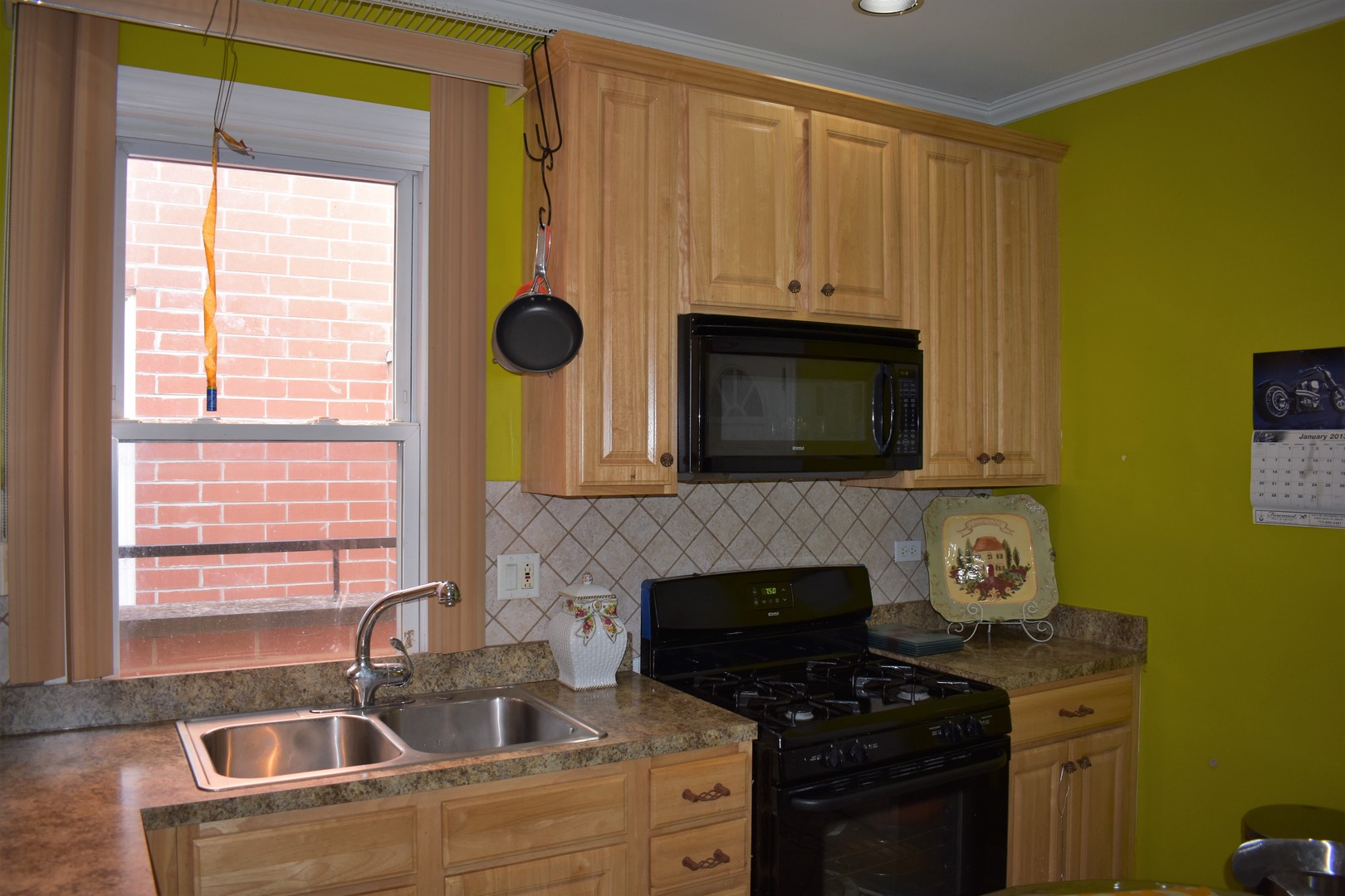 3539 North Pulaski Road Chicago, IL 60641 - Photo 3 of 23 a kitchen with a sink a stove and cabinets