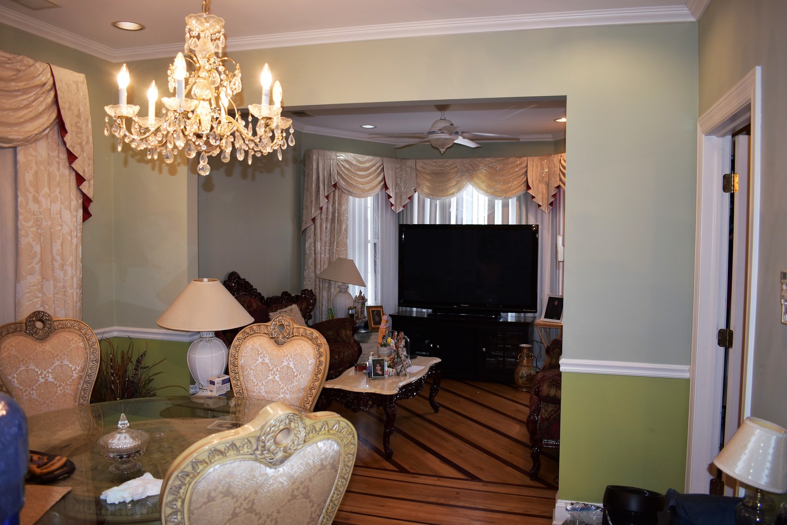 3539 North Pulaski Road Chicago, IL 60641 - Photo 8 of 23 a living room with furniture a chandelier and a flat screen tv
