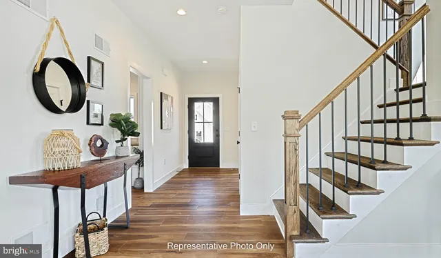 a view of an entryway with wooden floor