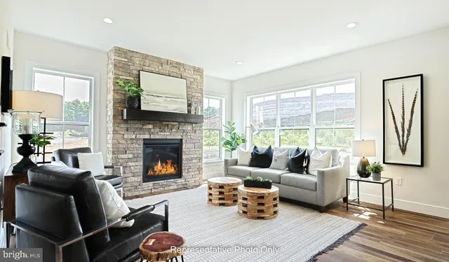 a living room with furniture fireplace and a large window