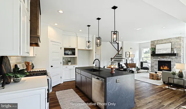 a kitchen with sink refrigerator and stove