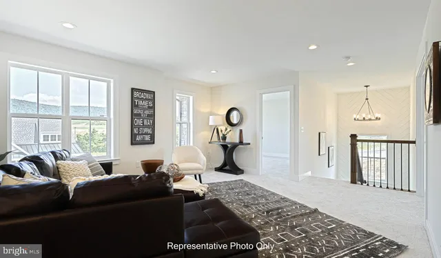 a living room with furniture a rug and a window