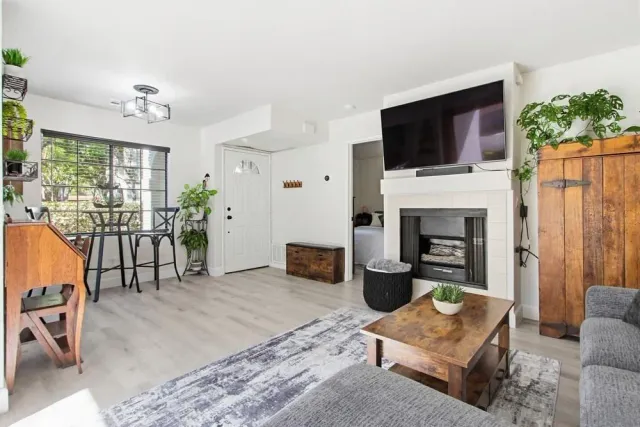 a living room with furniture a fireplace and a flat screen tv