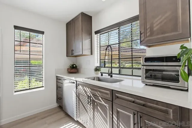 a kitchen with a sink and large window