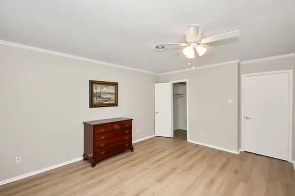 a view of a livingroom with wooden floor and a ceiling fan