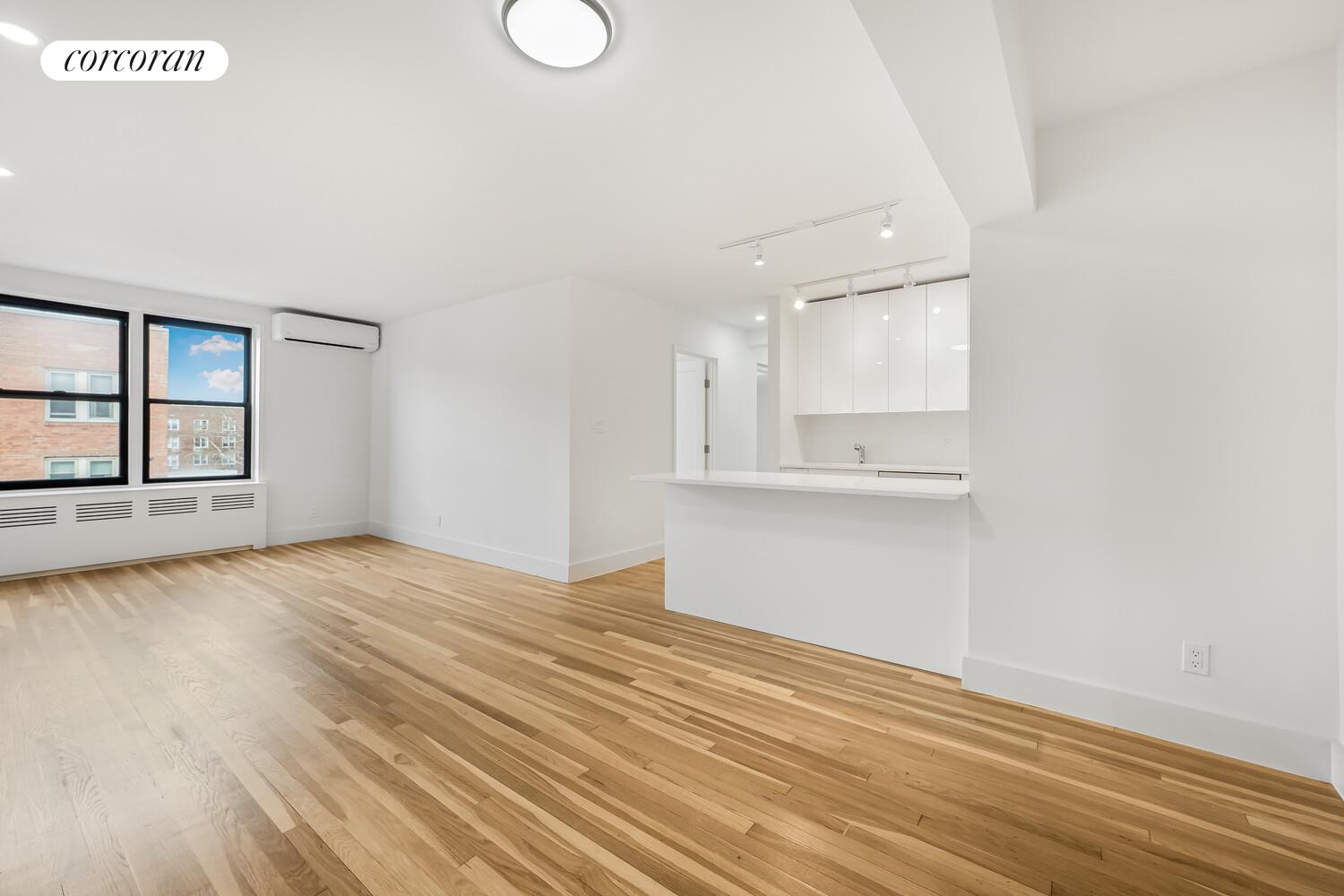9511 Shore Road, Unit 609 Brooklyn, NY 11209 - Photo 2 of 16 a view of empty room with wooden floor and fan