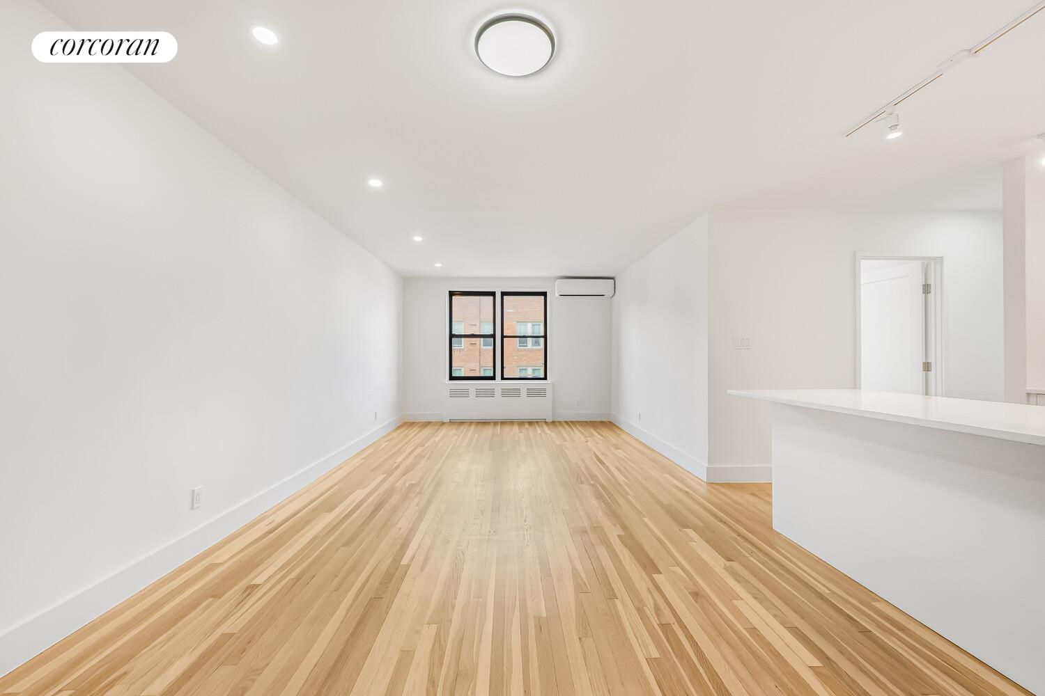 9511 Shore Road, Unit 609 Brooklyn, NY 11209 - Photo 3 of 16 wooden floor in an empty room with a window