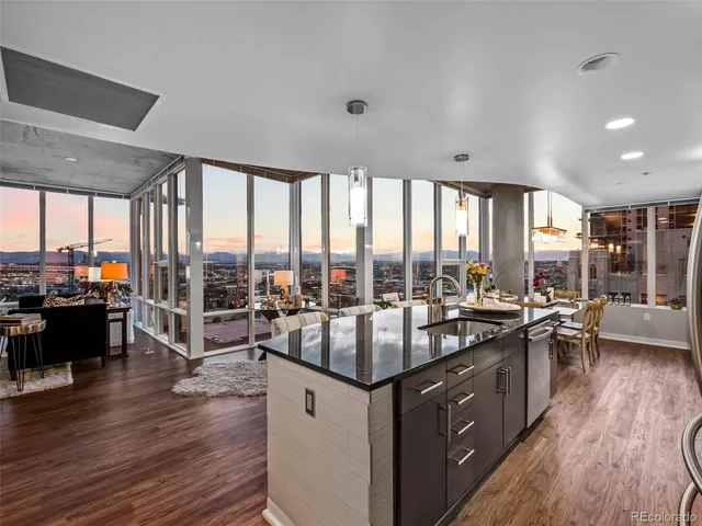 a very nice looking living room with a large window and wooden floor