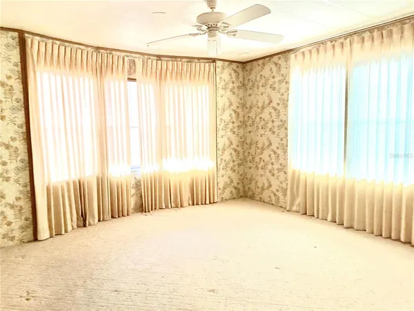 a view of a bedroom with a window and a bathroom