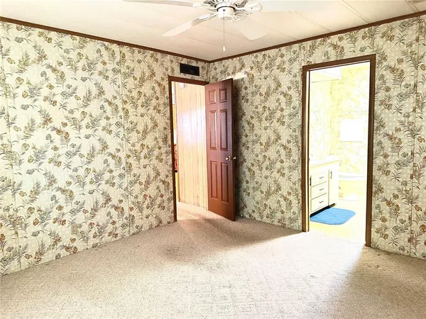 a view of entryway with window and a ceiling fan