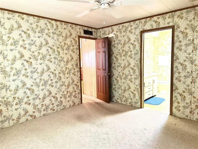 a view of entryway with window and a ceiling fan