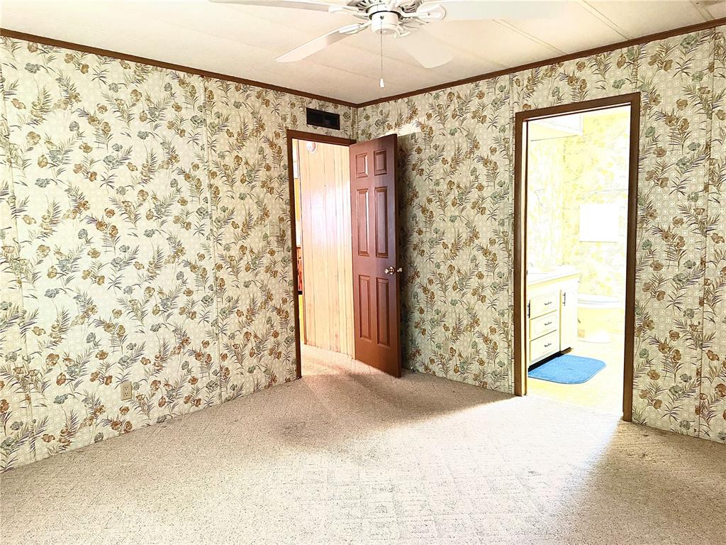 8242 Fiesta Street Brooksville, FL 34613 - Photo 13 of 31 a view of entryway with window and a ceiling fan