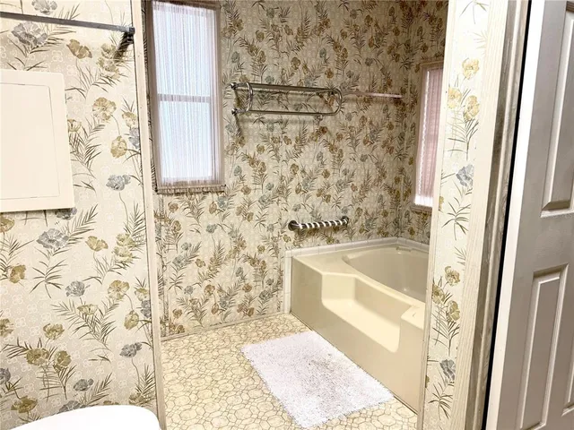 a bathroom with a bathtub and shower