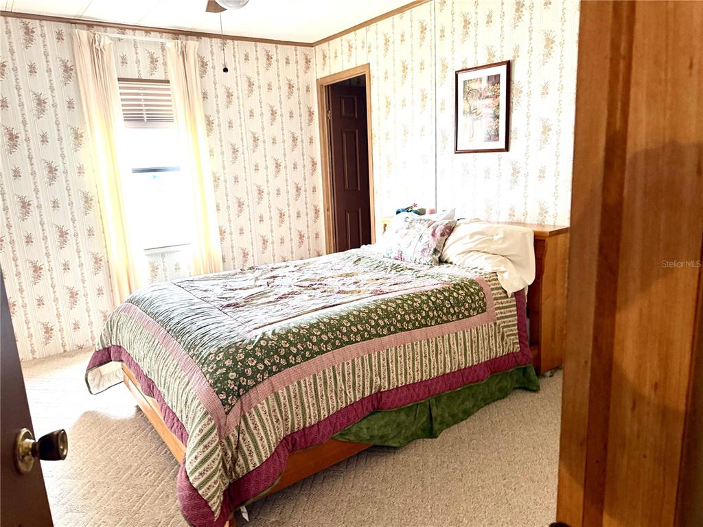8242 Fiesta Street Brooksville, FL 34613 - Photo 17 of 31 a bedroom with a bed and a window