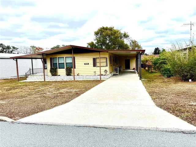 a front view of a house with trees