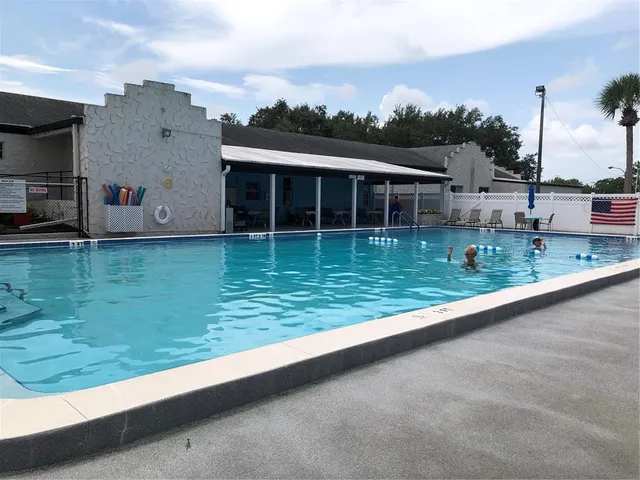 a view of a large pool with a yard