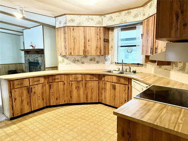 a kitchen with stainless steel appliances kitchen island granite countertop a sink and cabinets