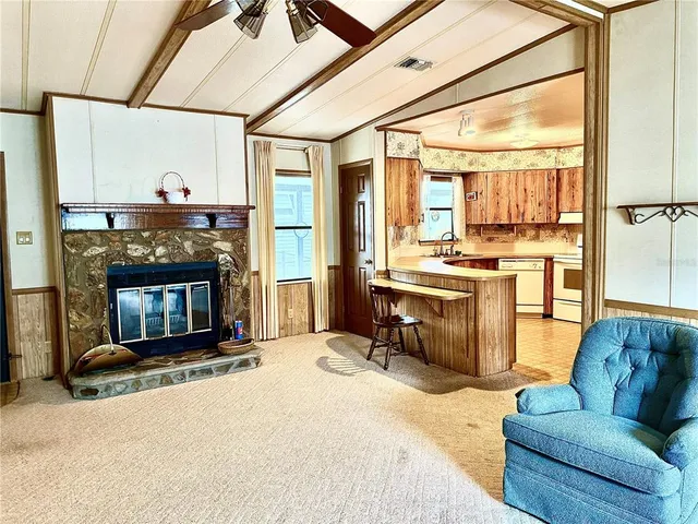 a living room with furniture a fireplace and a table