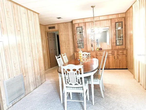 a dining room with furniture and window