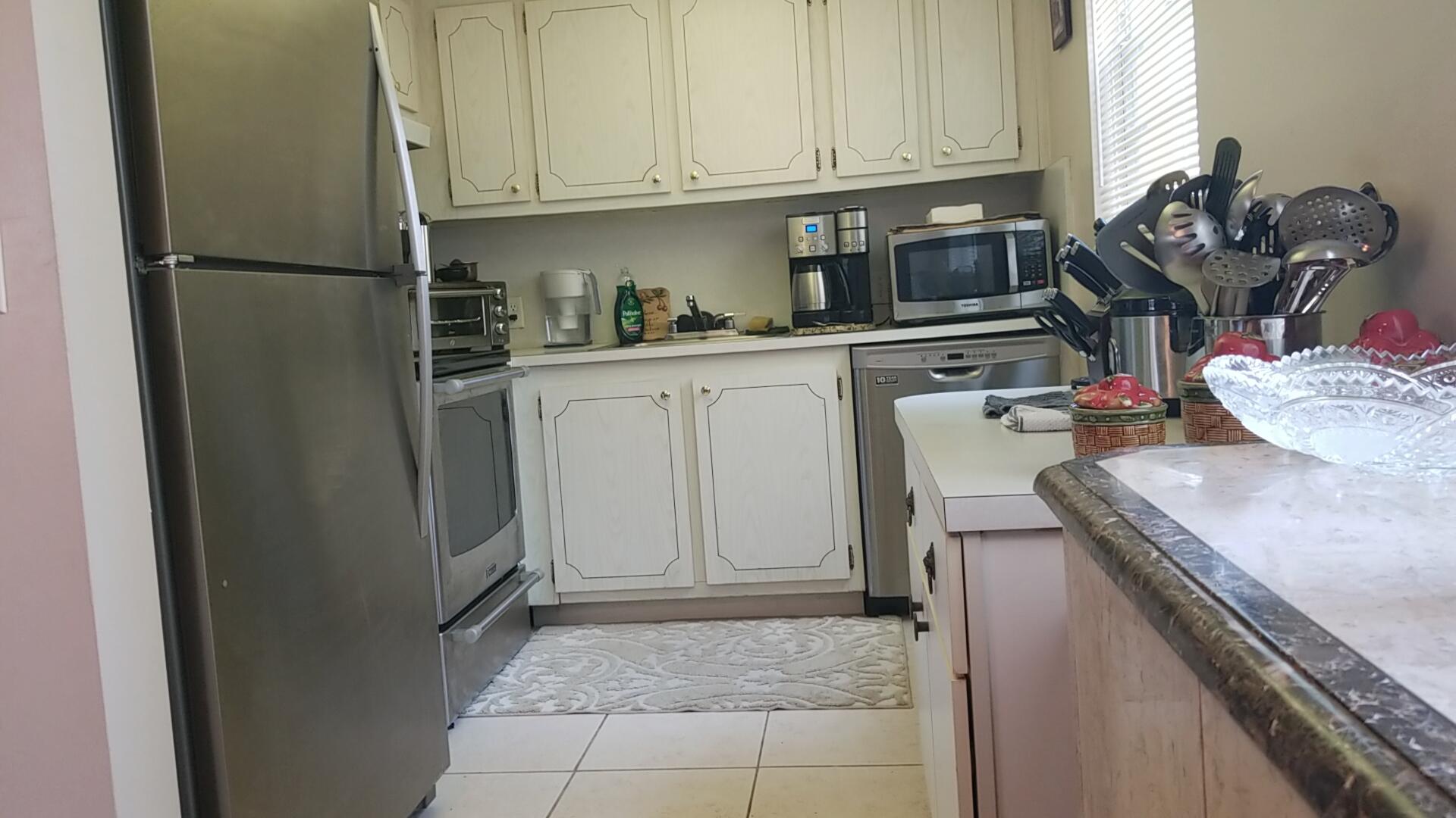 94 Dorset C Boca Raton, FL 33434 - Photo 11 of 20 a kitchen with refrigerator and cabinets