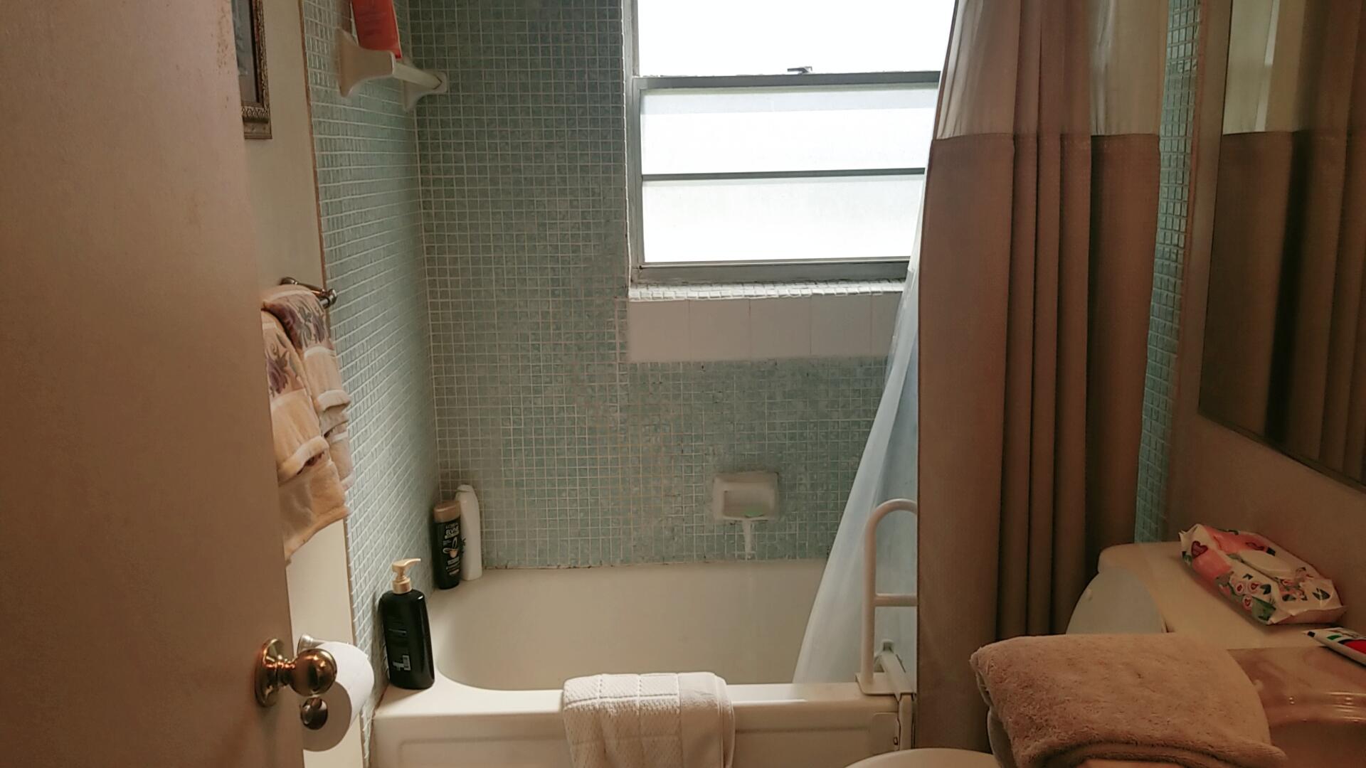 94 Dorset C Boca Raton, FL 33434 - Photo 14 of 20 a bathroom with a tub and shower