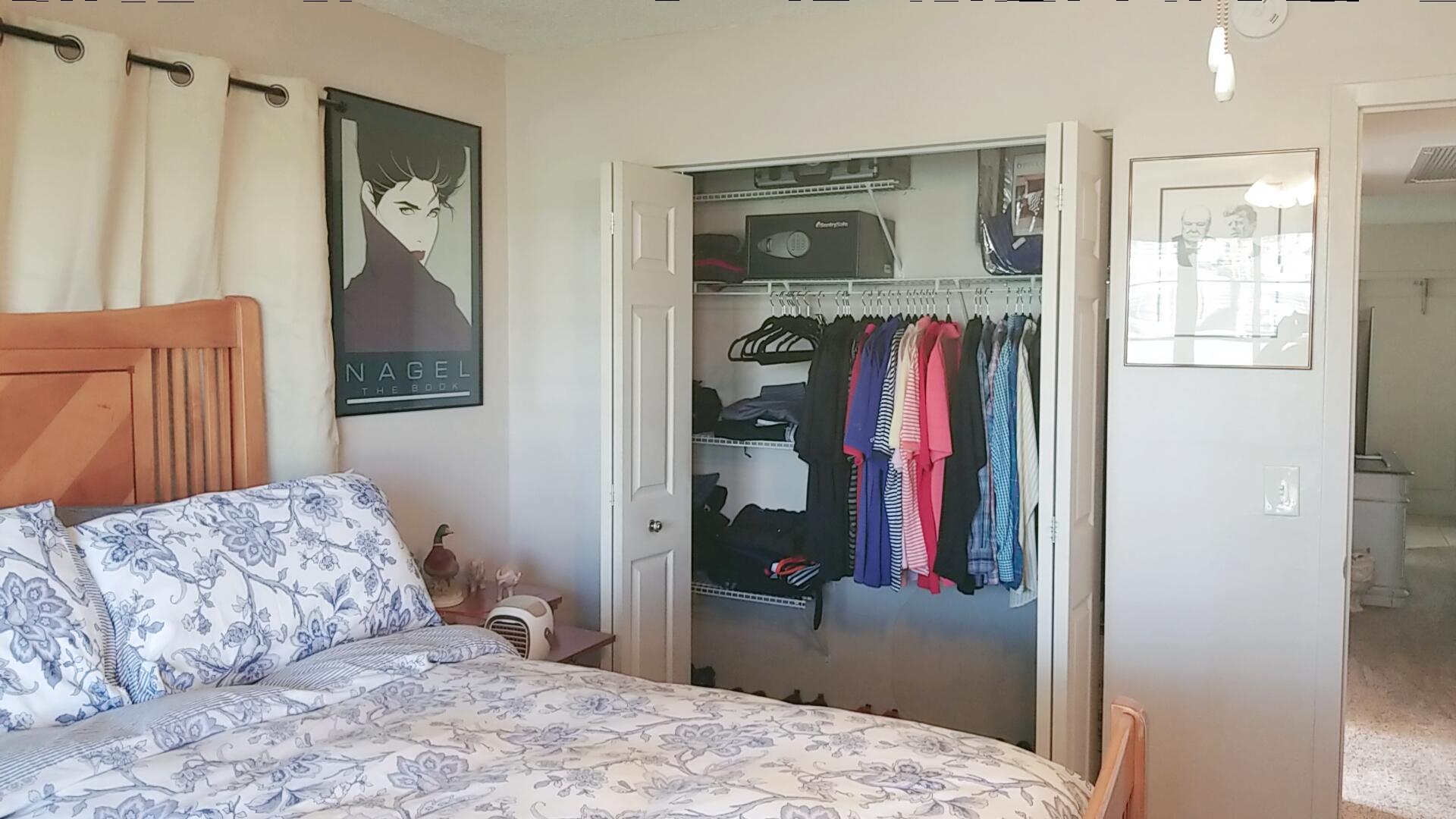 94 Dorset C Boca Raton, FL 33434 - Photo 16 of 20 a bedroom with a bed and a dresser