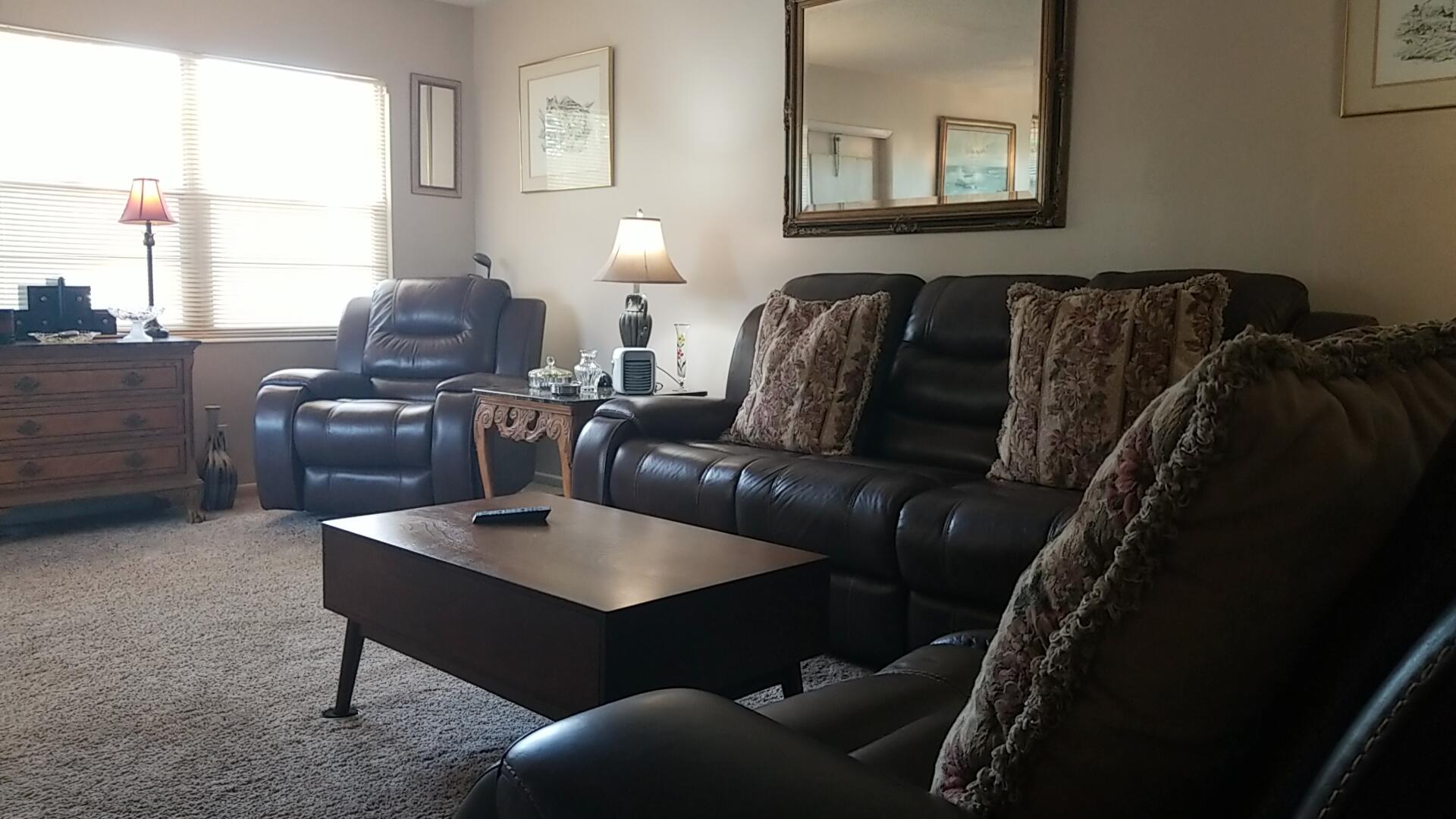 94 Dorset C Boca Raton, FL 33434 - Photo 8 of 20 a living room with furniture a window and a lamp