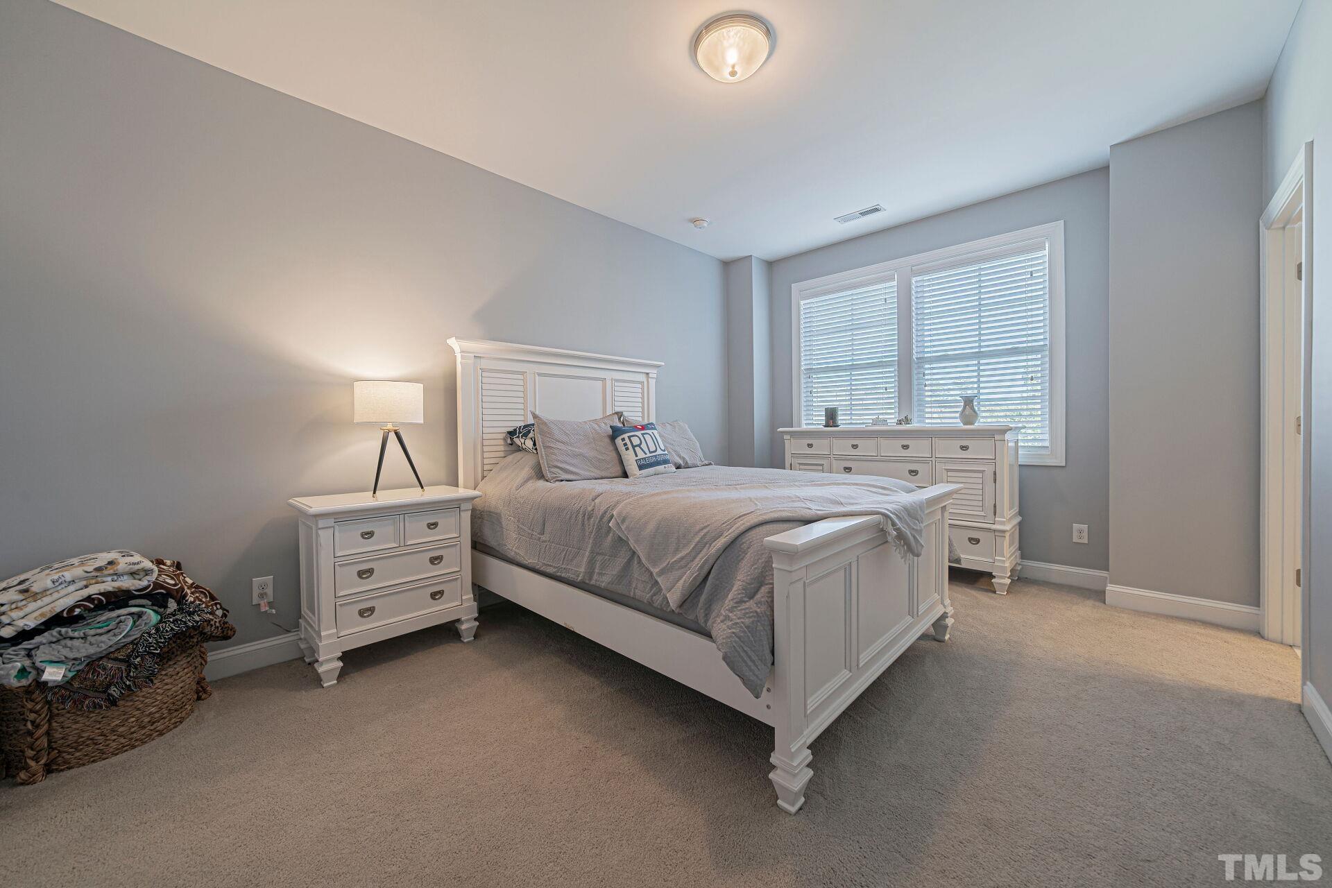 3604 Winifred Way Raleigh, NC 27609 - Photo 13 of 19 a bedroom with a bed and a window